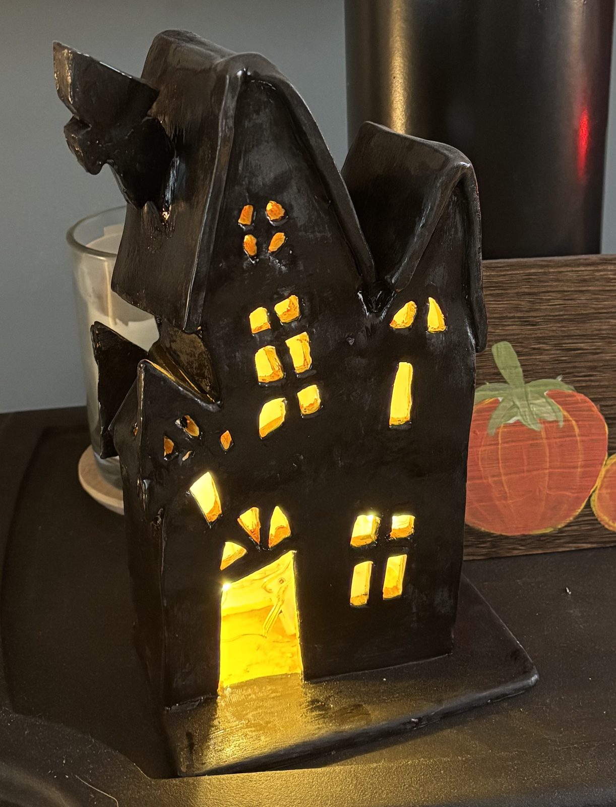 Glowing clay tea light house