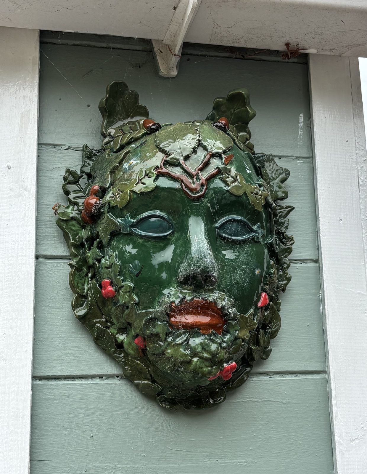 Hand-sculpted green man plaque