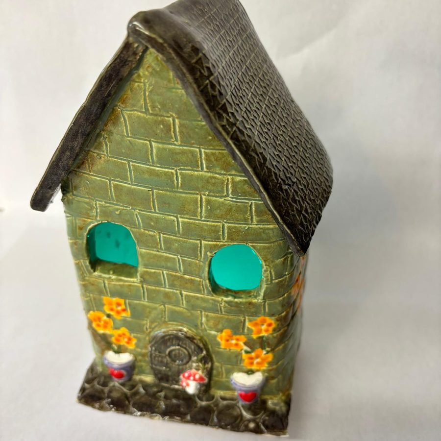 A finished clay tea light house at The Atelier