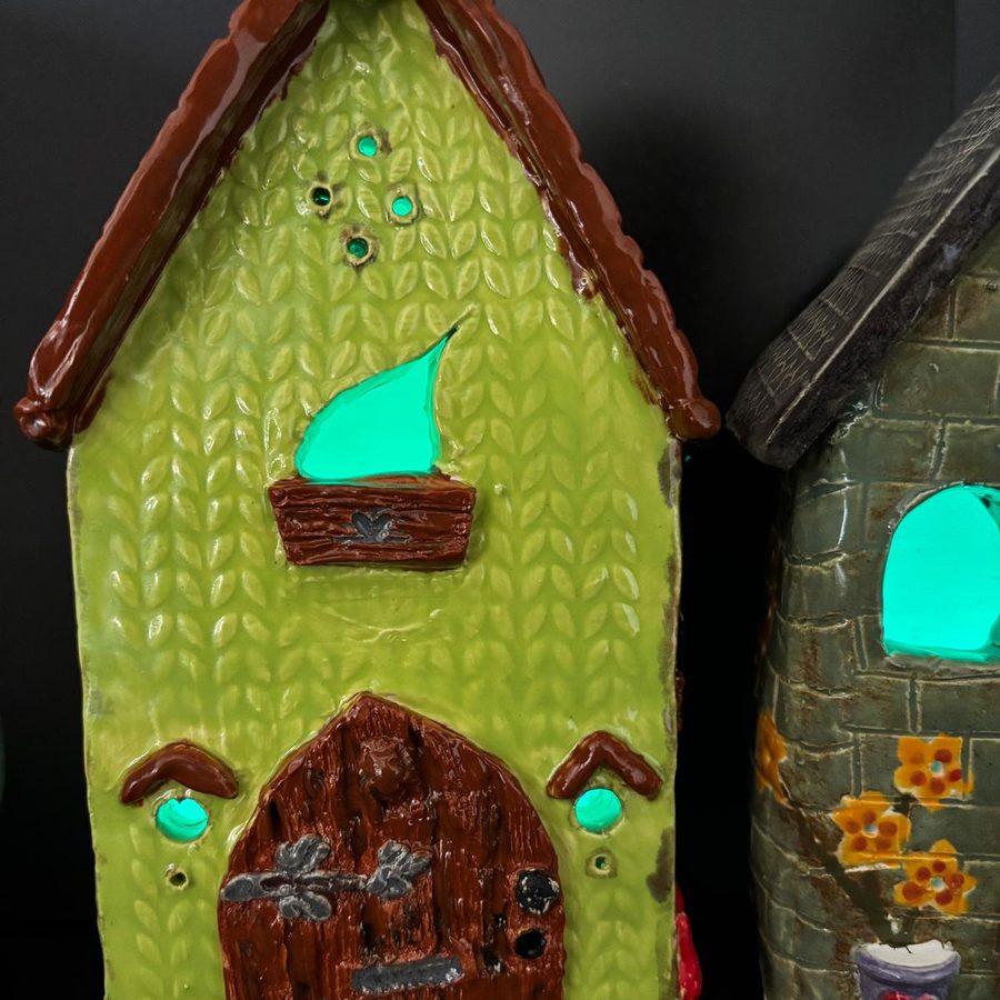 A clay tea light house lit from within