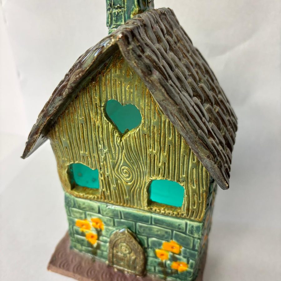 A finished clay tea light house, glazed