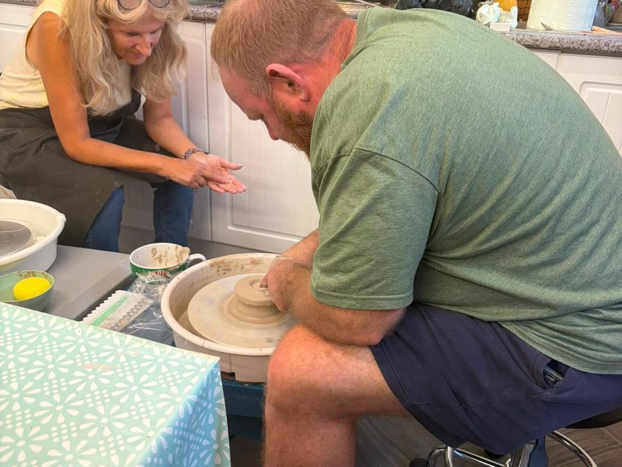 Having a go on the wheel.
